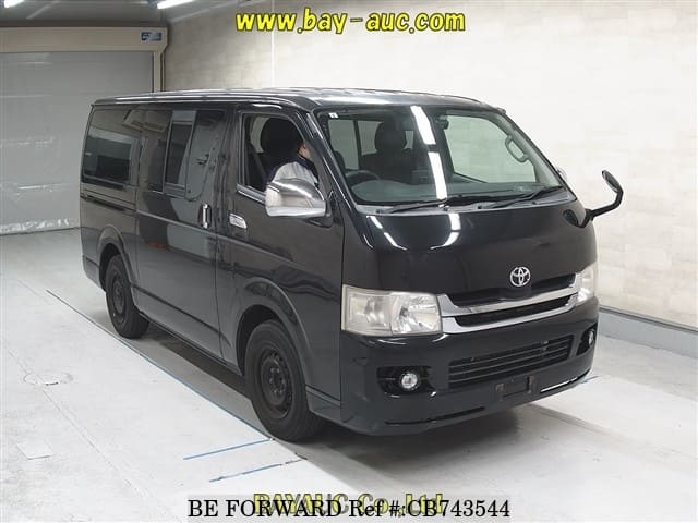 A grey JDM sports car speeding down a highway at night.