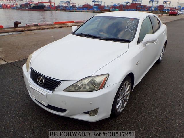 A grey JDM sports car speeding down a highway at night.