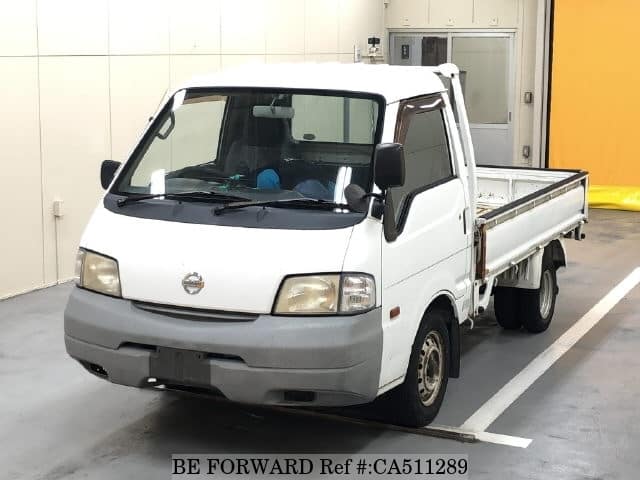 A grey JDM sports car speeding down a highway at night.