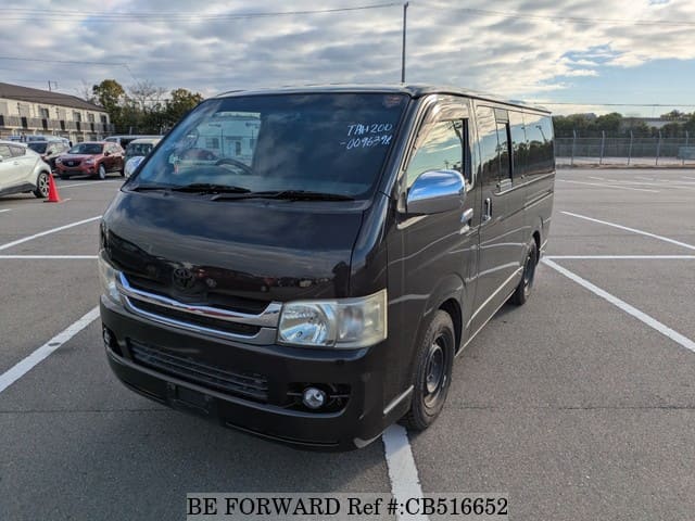 A grey JDM sports car speeding down a highway at night.