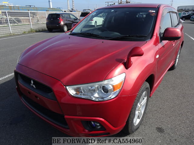 A grey JDM sports car speeding down a highway at night.