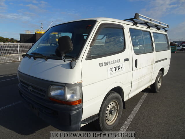 A grey JDM sports car speeding down a highway at night.