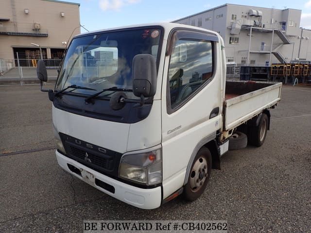 A grey JDM sports car speeding down a highway at night.