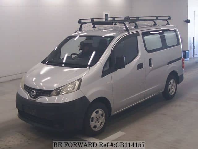 A grey JDM sports car speeding down a highway at night.