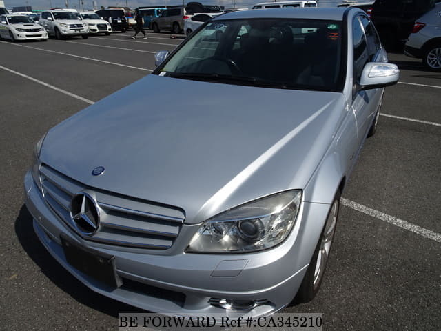 A grey JDM sports car speeding down a highway at night.