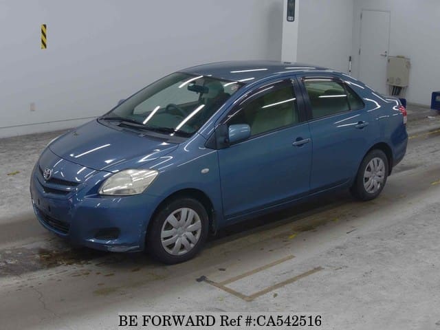 A grey JDM sports car speeding down a highway at night.