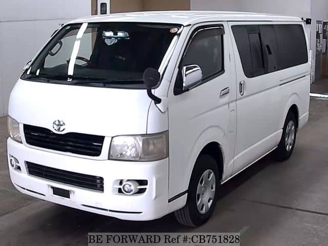A grey JDM sports car speeding down a highway at night.