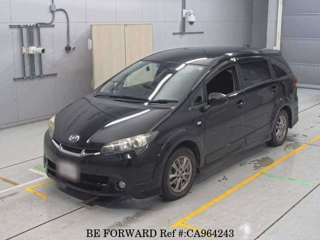 A grey JDM sports car speeding down a highway at night.