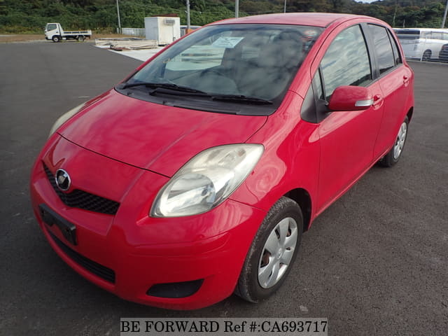 A grey JDM sports car speeding down a highway at night.