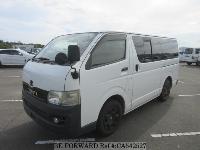 A grey JDM sports car speeding down a highway at night.