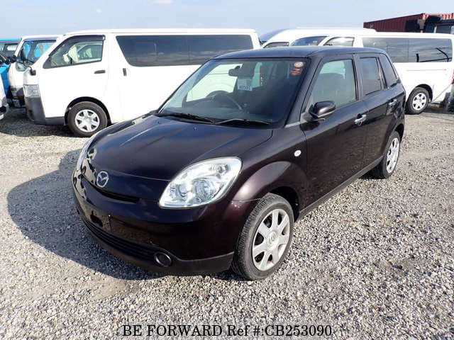 A grey JDM sports car speeding down a highway at night.
