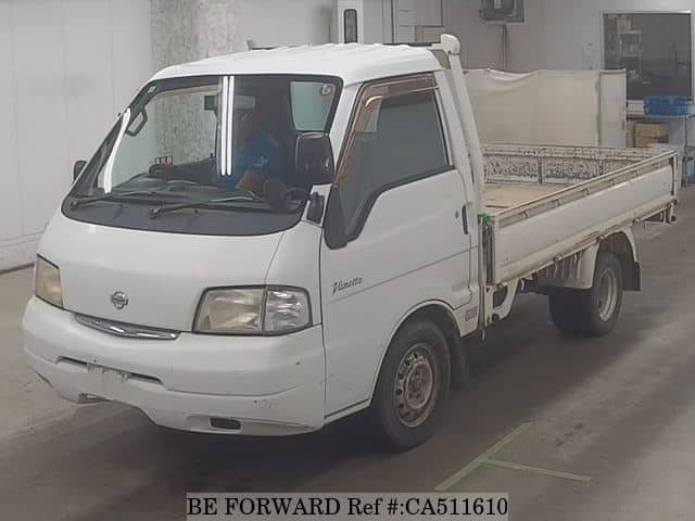 A grey JDM sports car speeding down a highway at night.