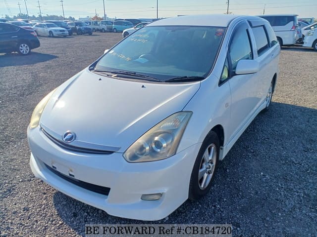 A grey JDM sports car speeding down a highway at night.