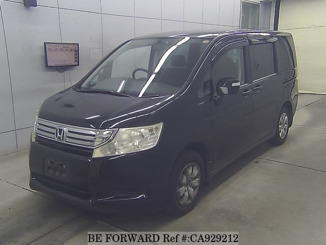 A grey JDM sports car speeding down a highway at night.