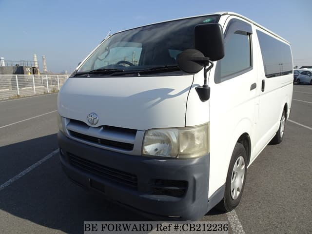 A grey JDM sports car speeding down a highway at night.