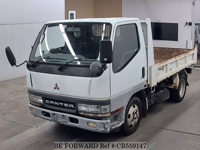 A grey JDM sports car speeding down a highway at night.