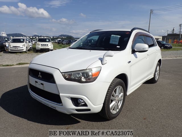 A grey JDM sports car speeding down a highway at night.