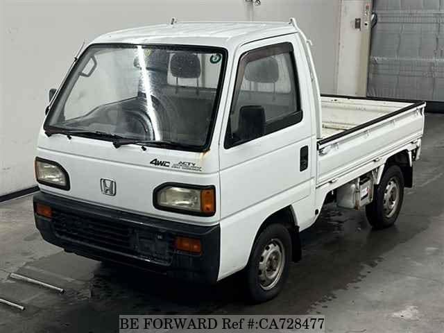 A grey JDM sports car speeding down a highway at night.