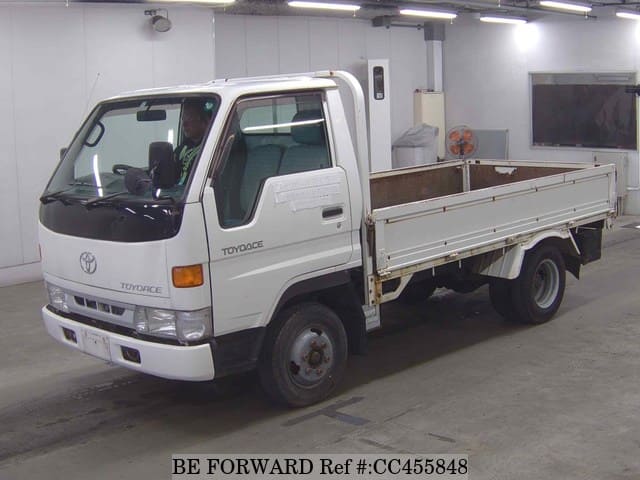 A grey JDM sports car speeding down a highway at night.