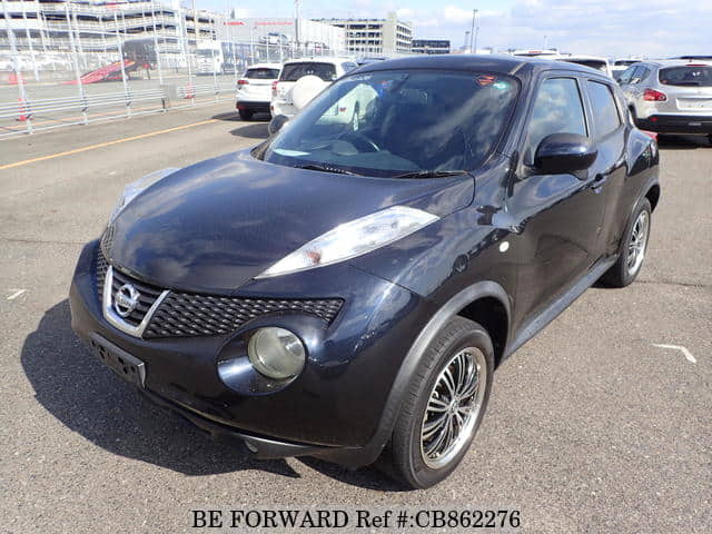 A grey JDM sports car speeding down a highway at night.