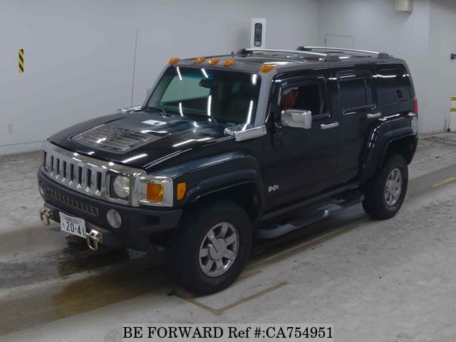 A grey JDM sports car speeding down a highway at night.