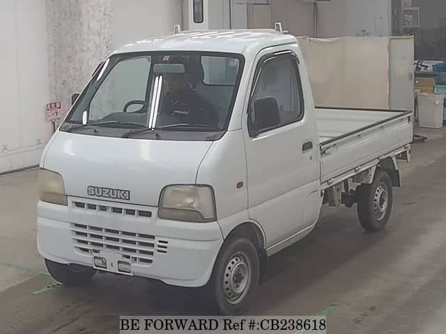 A grey JDM sports car speeding down a highway at night.