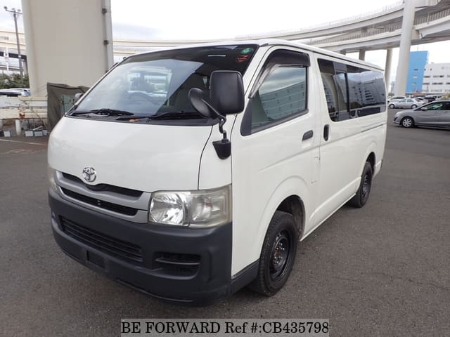 A grey JDM sports car speeding down a highway at night.