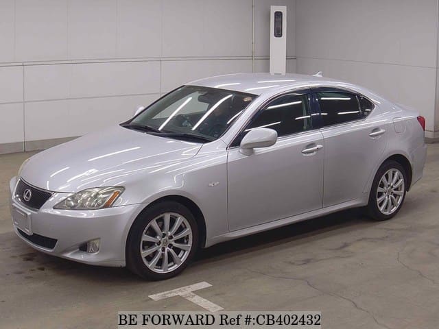 A grey JDM sports car speeding down a highway at night.