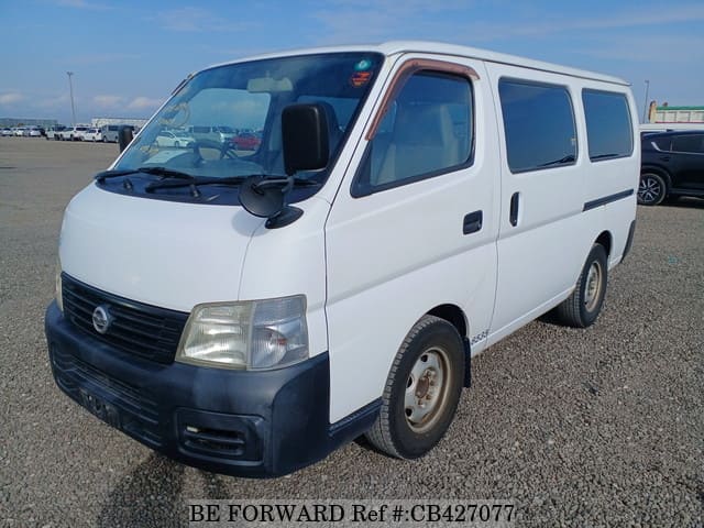 A grey JDM sports car speeding down a highway at night.