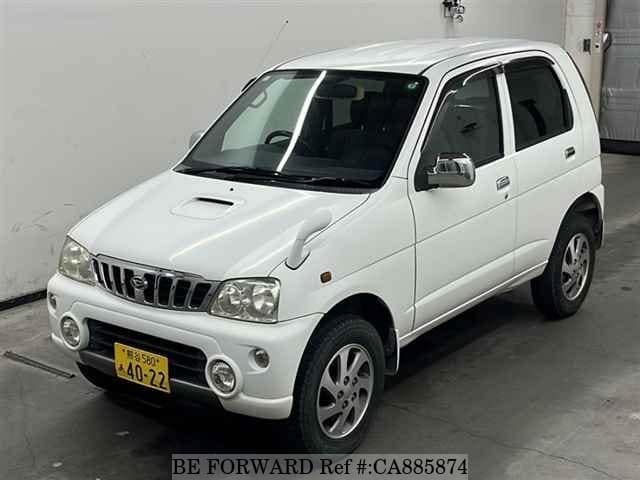A grey JDM sports car speeding down a highway at night.