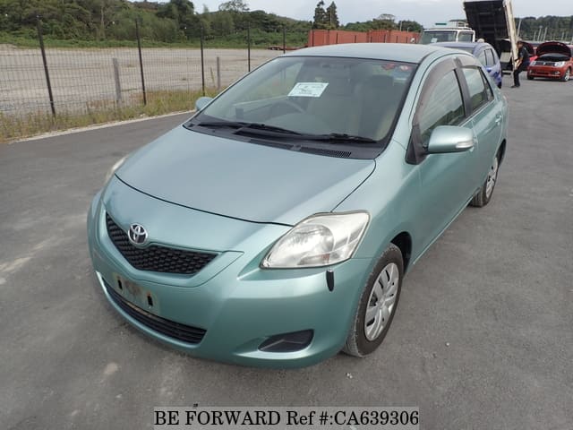 A grey JDM sports car speeding down a highway at night.