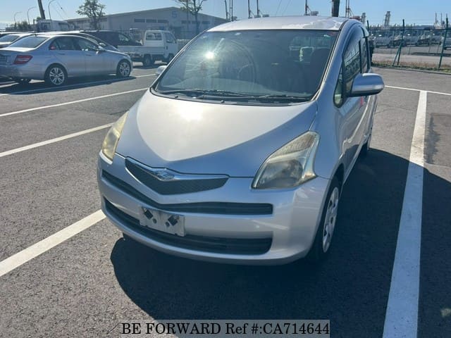 A grey JDM sports car speeding down a highway at night.