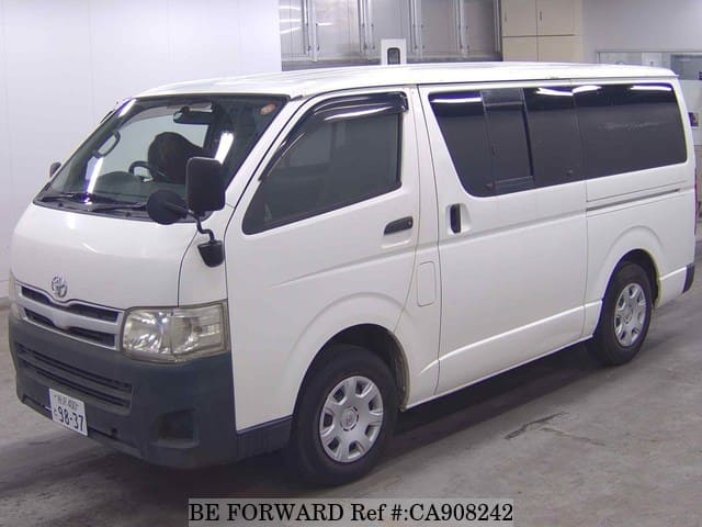 A grey JDM sports car speeding down a highway at night.