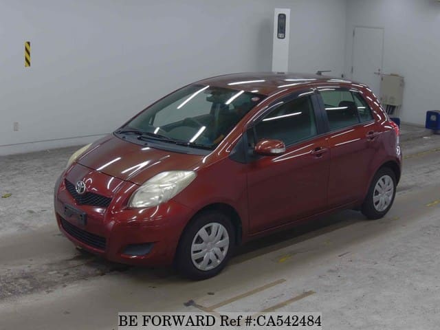 A grey JDM sports car speeding down a highway at night.