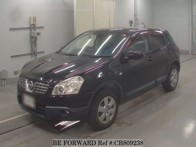 A grey JDM sports car speeding down a highway at night.