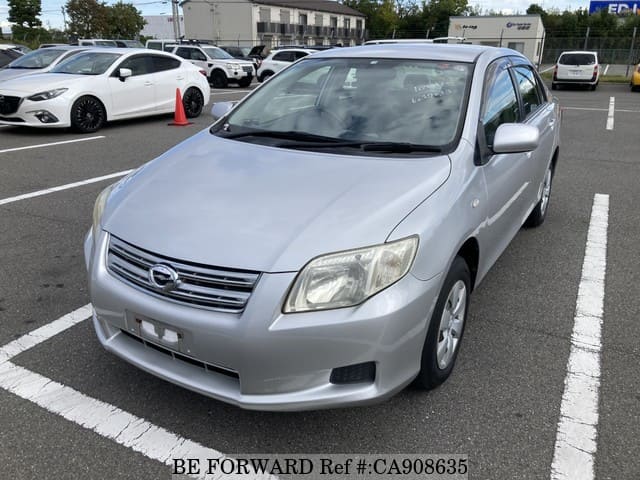 A grey JDM sports car speeding down a highway at night.