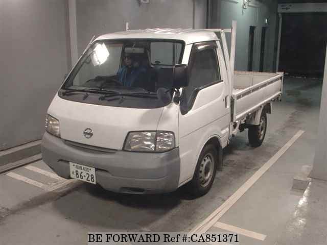 A grey JDM sports car speeding down a highway at night.