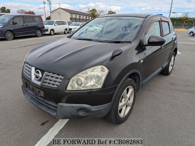 A grey JDM sports car speeding down a highway at night.