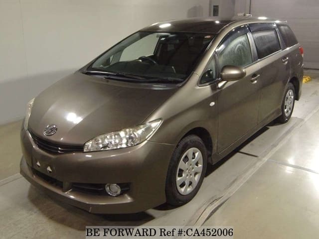 A grey JDM sports car speeding down a highway at night.