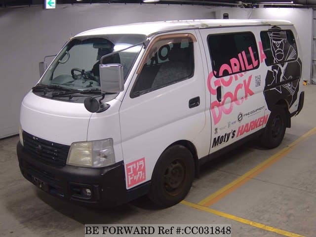 A grey sports car speeding down a highway at night.