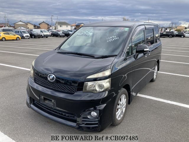 A grey JDM sports car speeding down a highway at night.