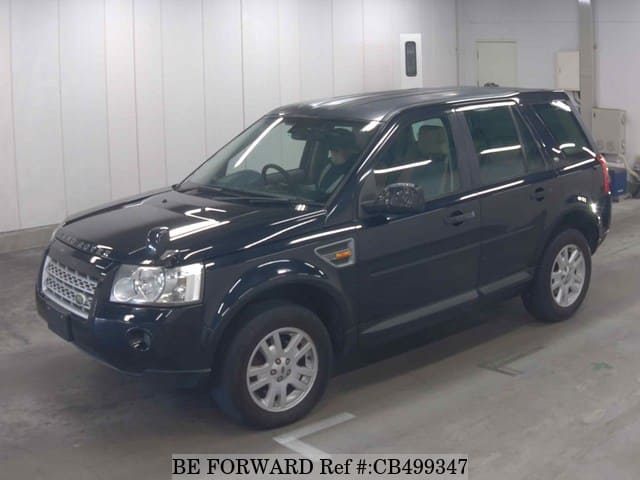 A grey JDM sports car speeding down a highway at night.