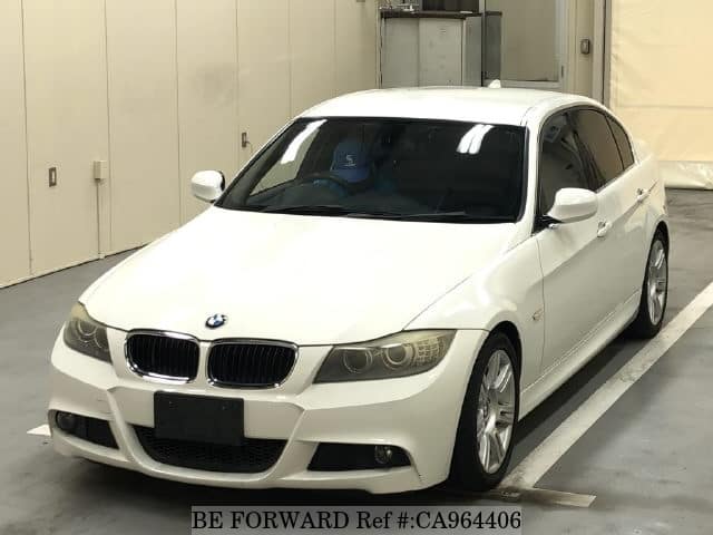 A grey sports car speeding down a highway at night.