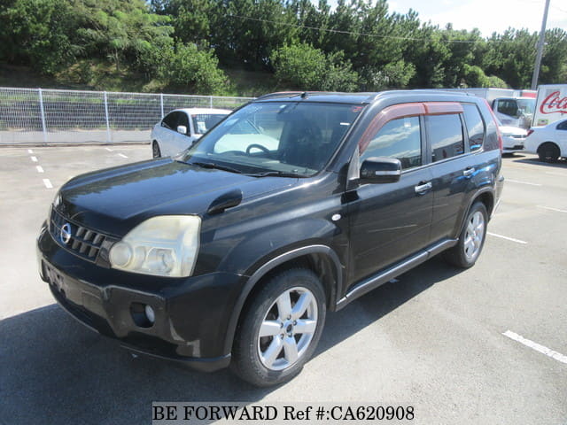 A grey JDM sports car speeding down a highway at night.