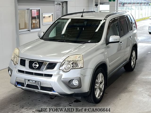 A grey JDM sports car speeding down a highway at night.