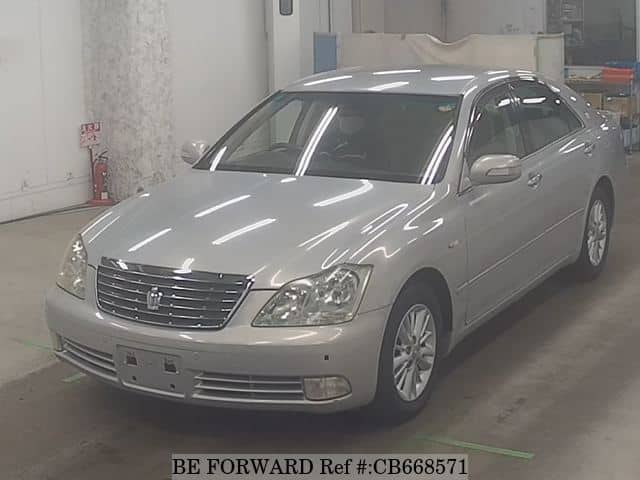 A grey JDM sports car speeding down a highway at night.