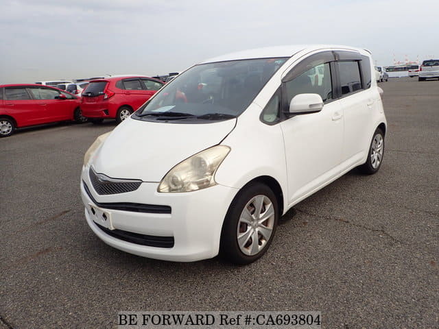 A grey JDM sports car speeding down a highway at night.