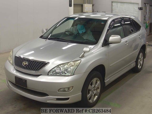 A grey JDM sports car speeding down a highway at night.