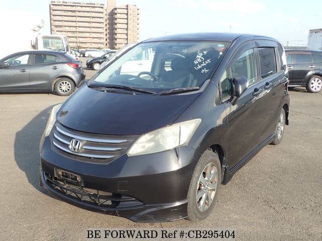 A grey JDM sports car speeding down a highway at night.