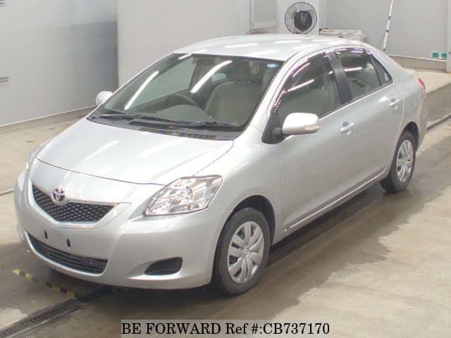 A grey JDM sports car speeding down a highway at night.